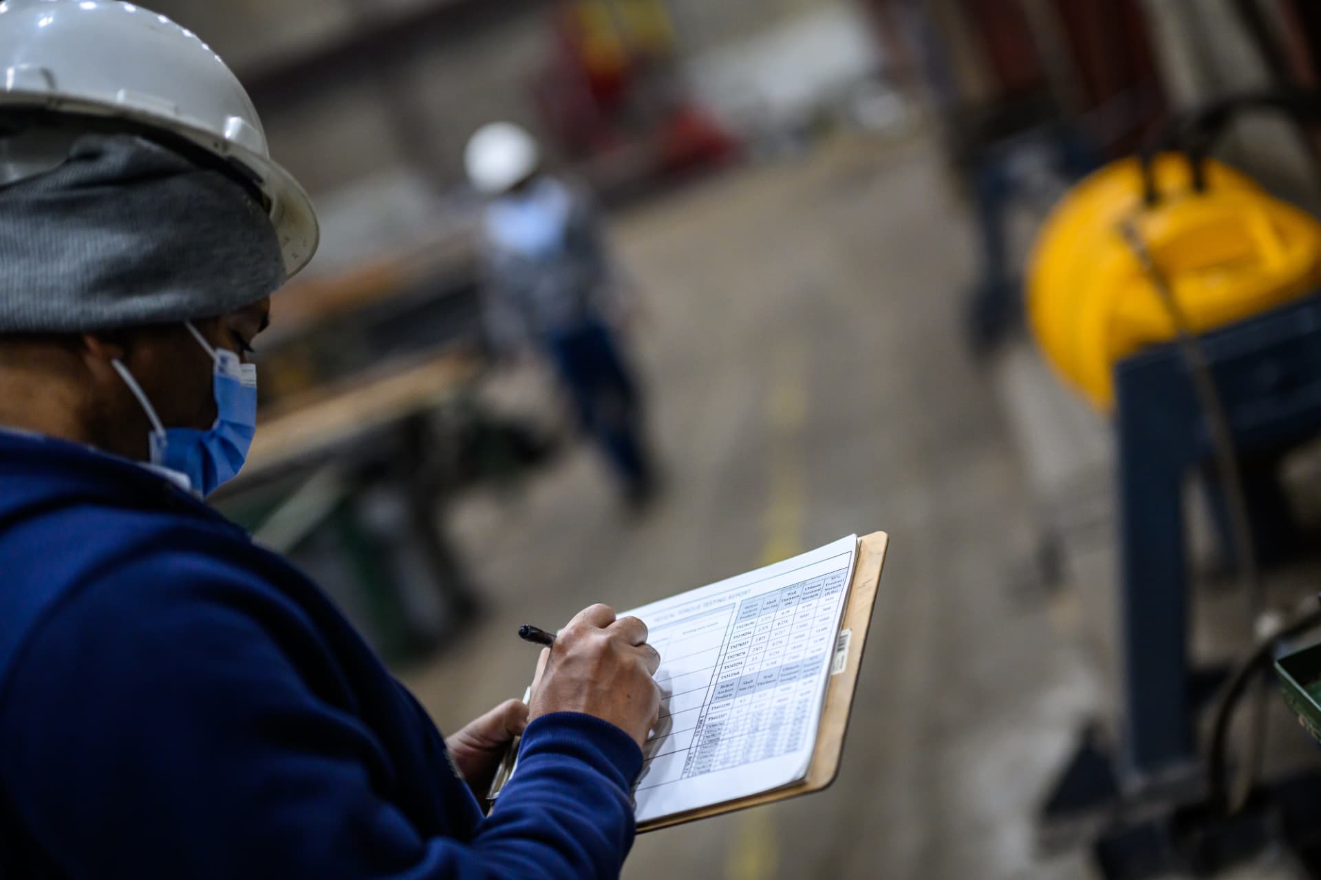 Helical Anchors team member recording manufacturing quality checks