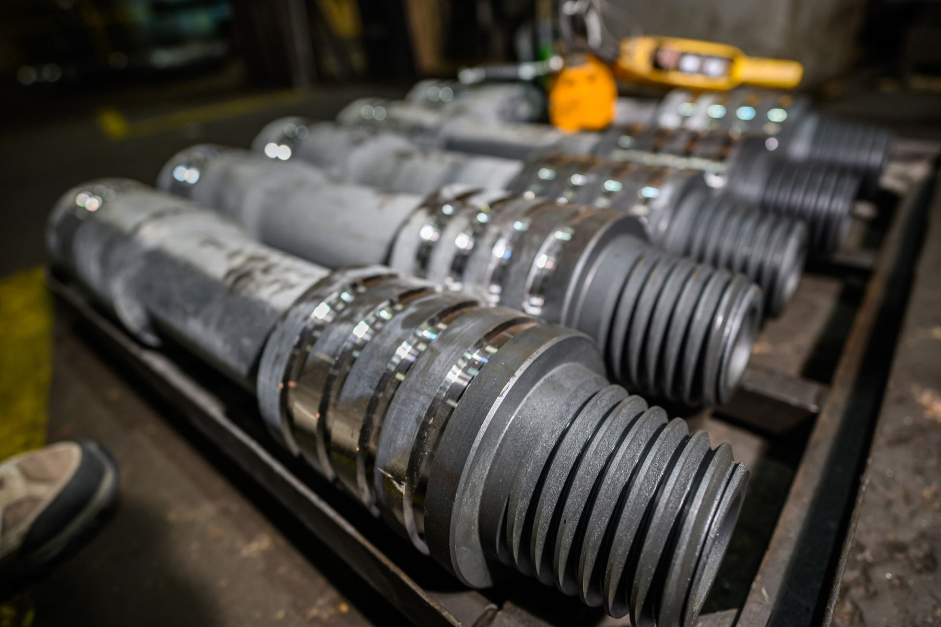 Machined threaded couplers staged for helical pile assembly